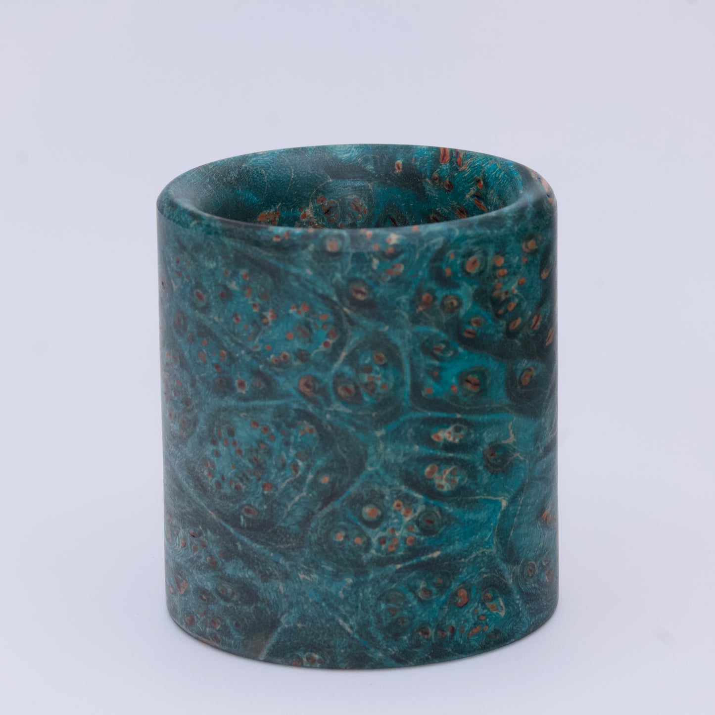 Blue  maple burl wood shot glass against white background