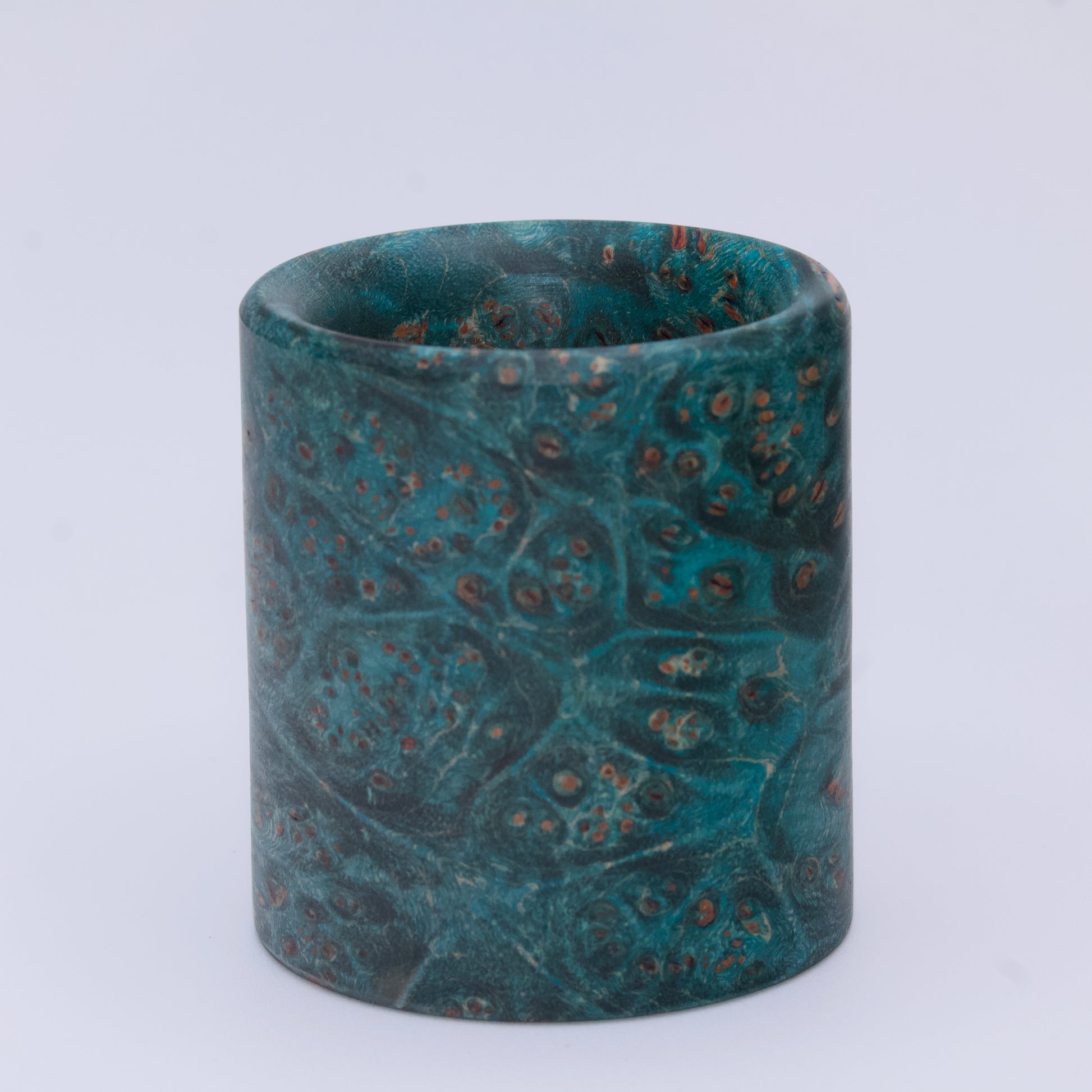 Blue  maple burl wood shot glass against white background
