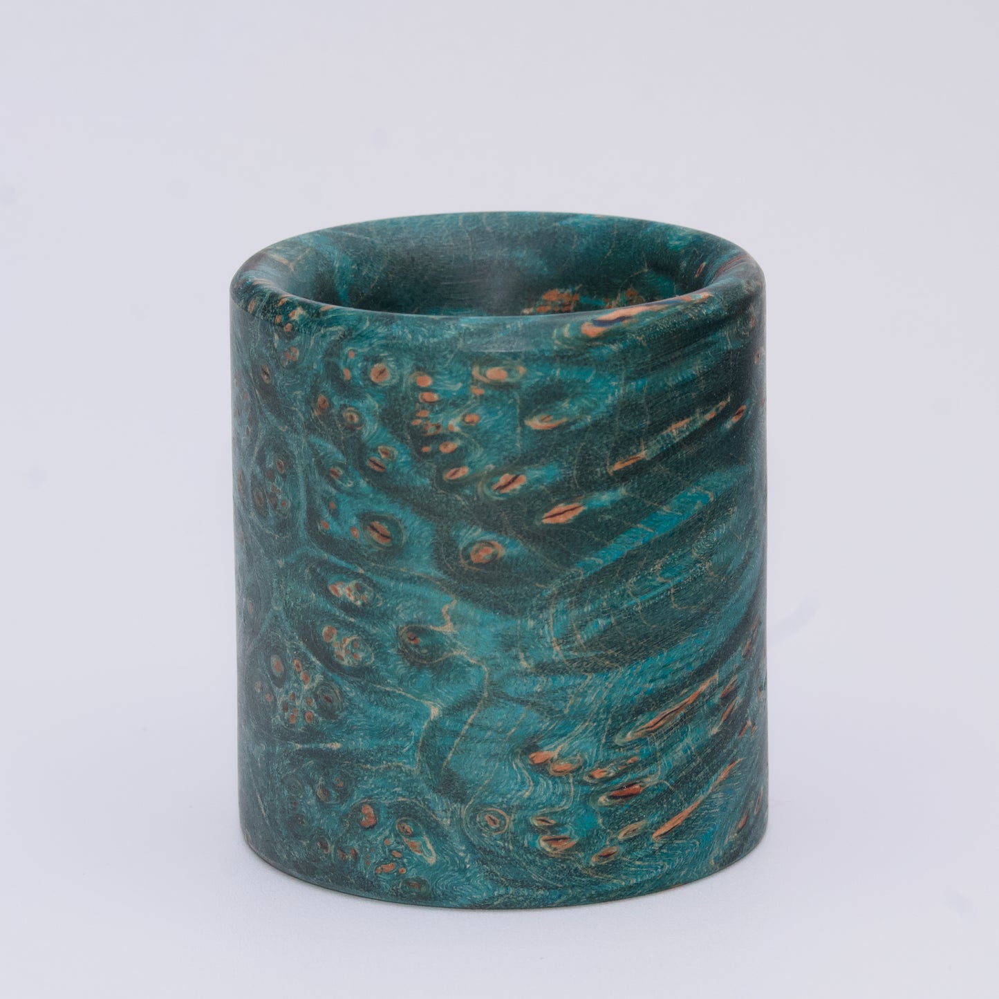 Blue  maple burl wood shot glass against white background