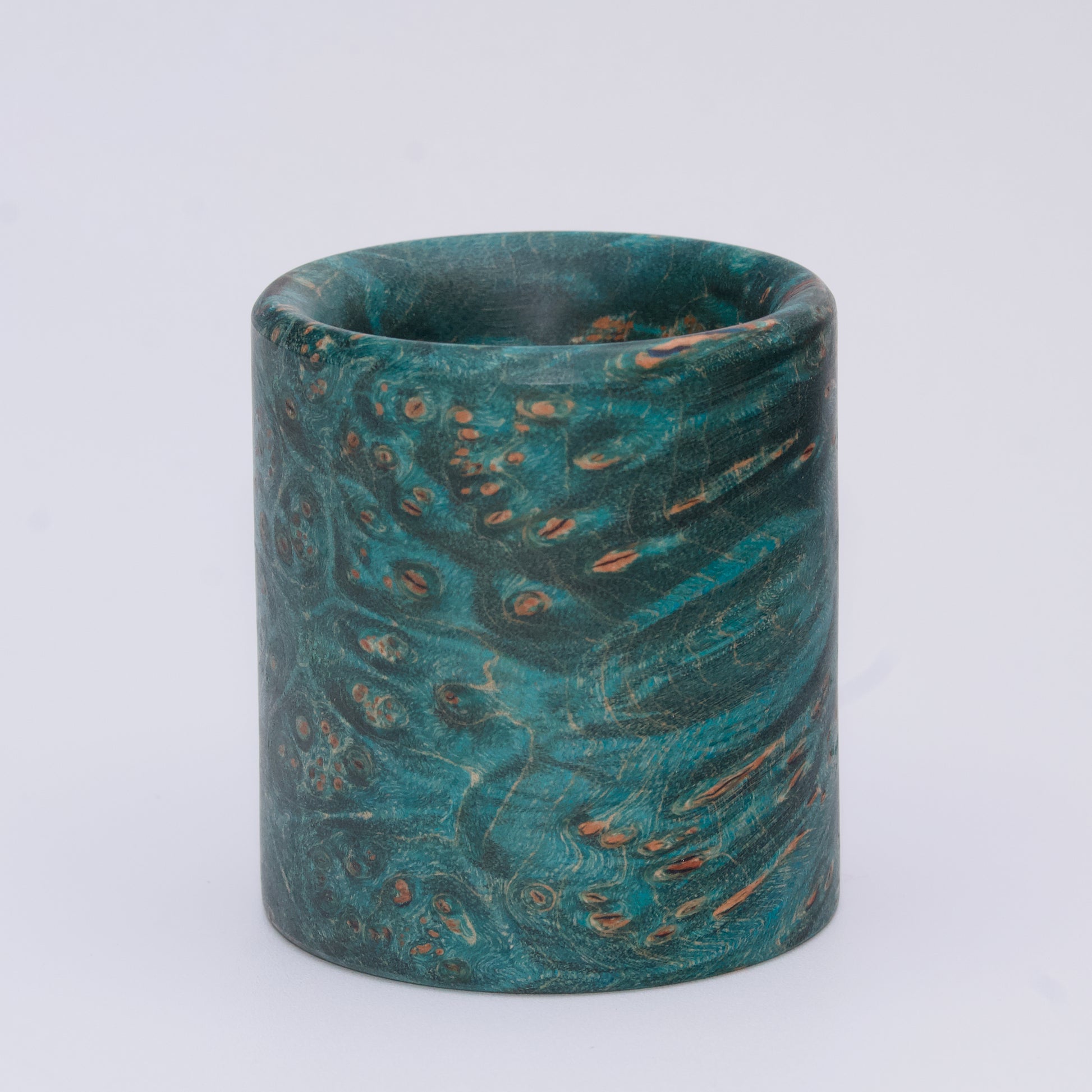 Blue  maple burl wood shot glass against white background