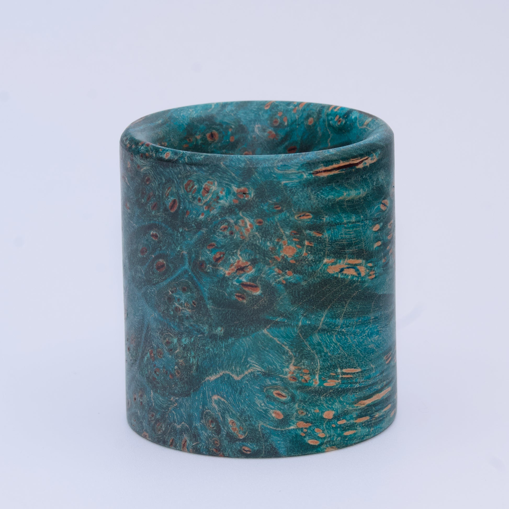 Blue  maple burl wood shot glass against white background