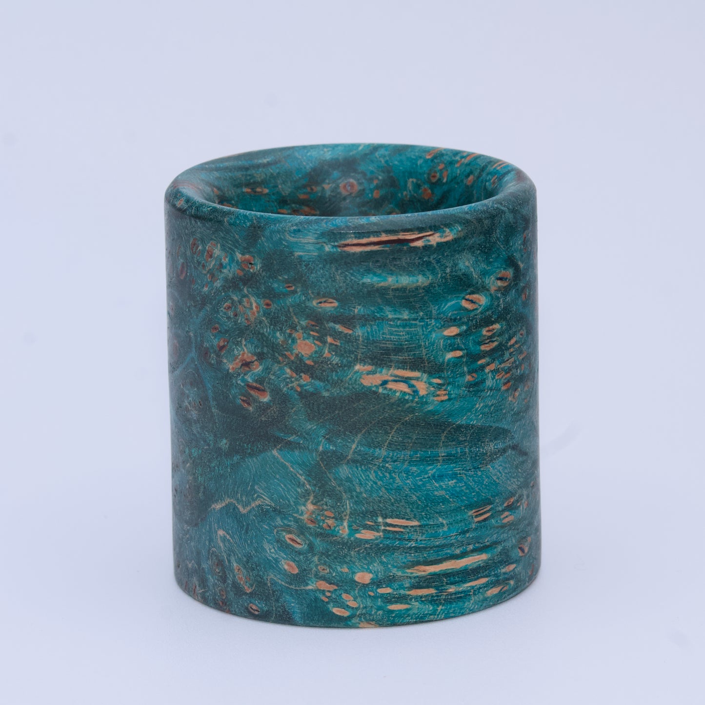 Blue  maple burl wood shot glass against white background