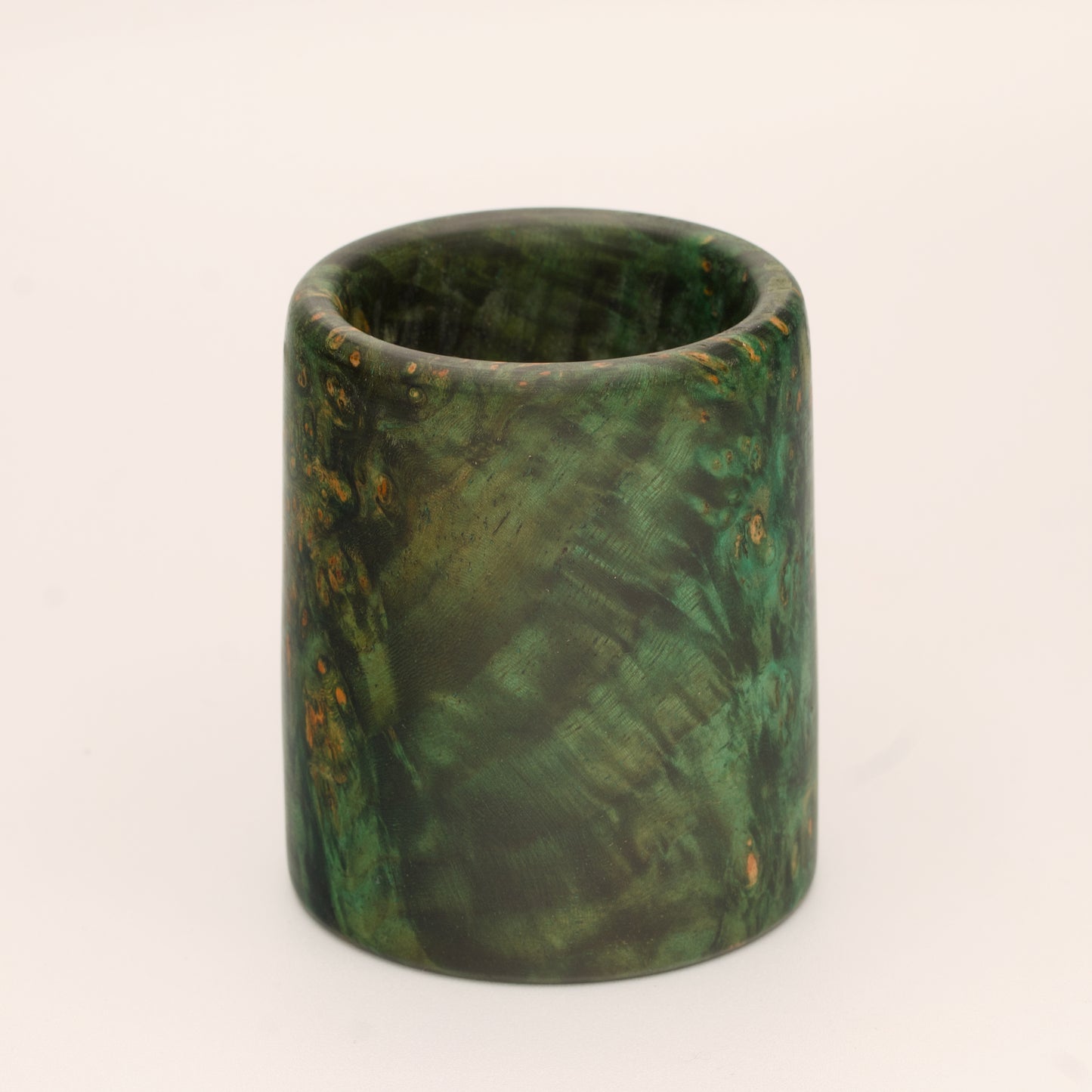Green river tamarind burl wood shot glass against white background