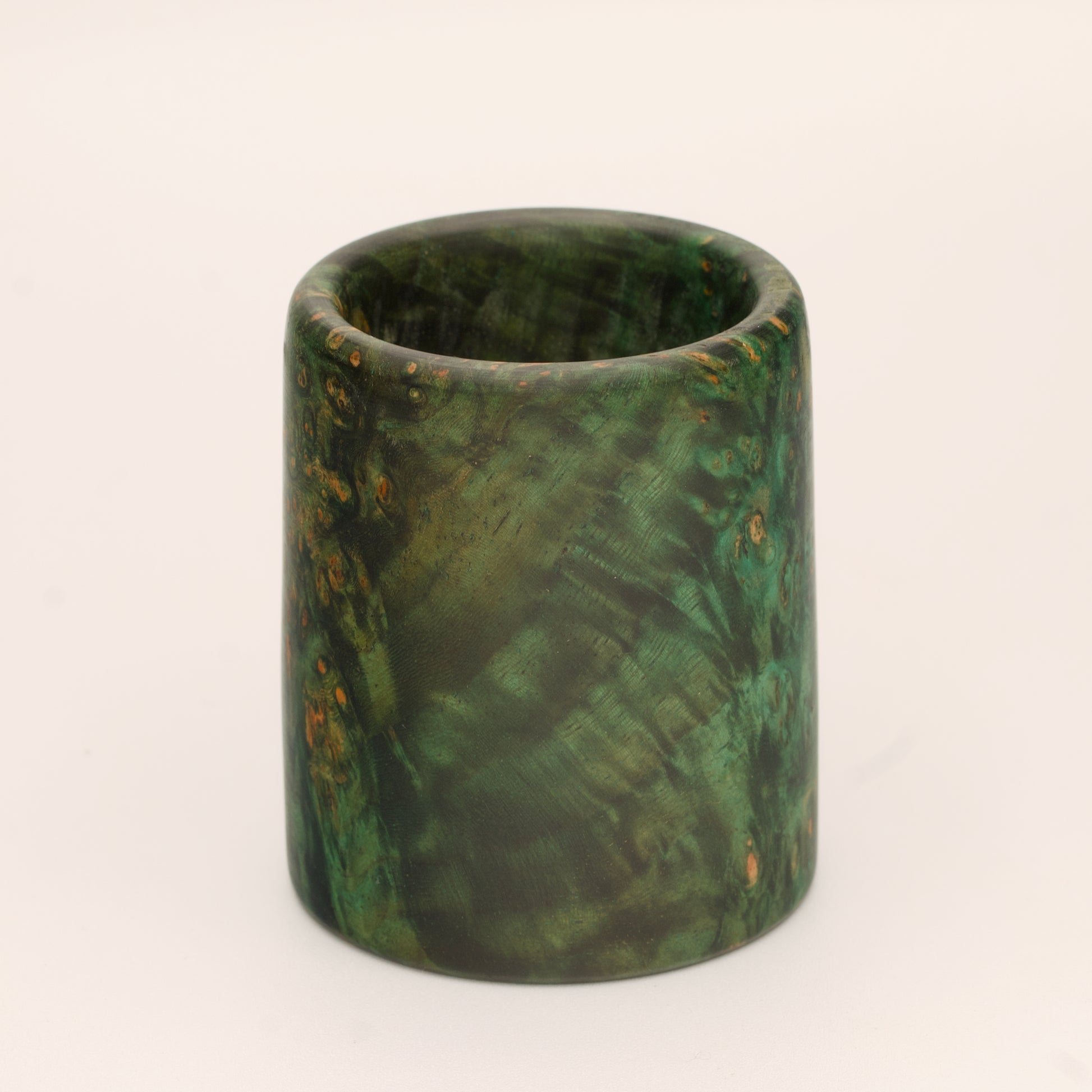 Green river tamarind burl wood shot glass against white background