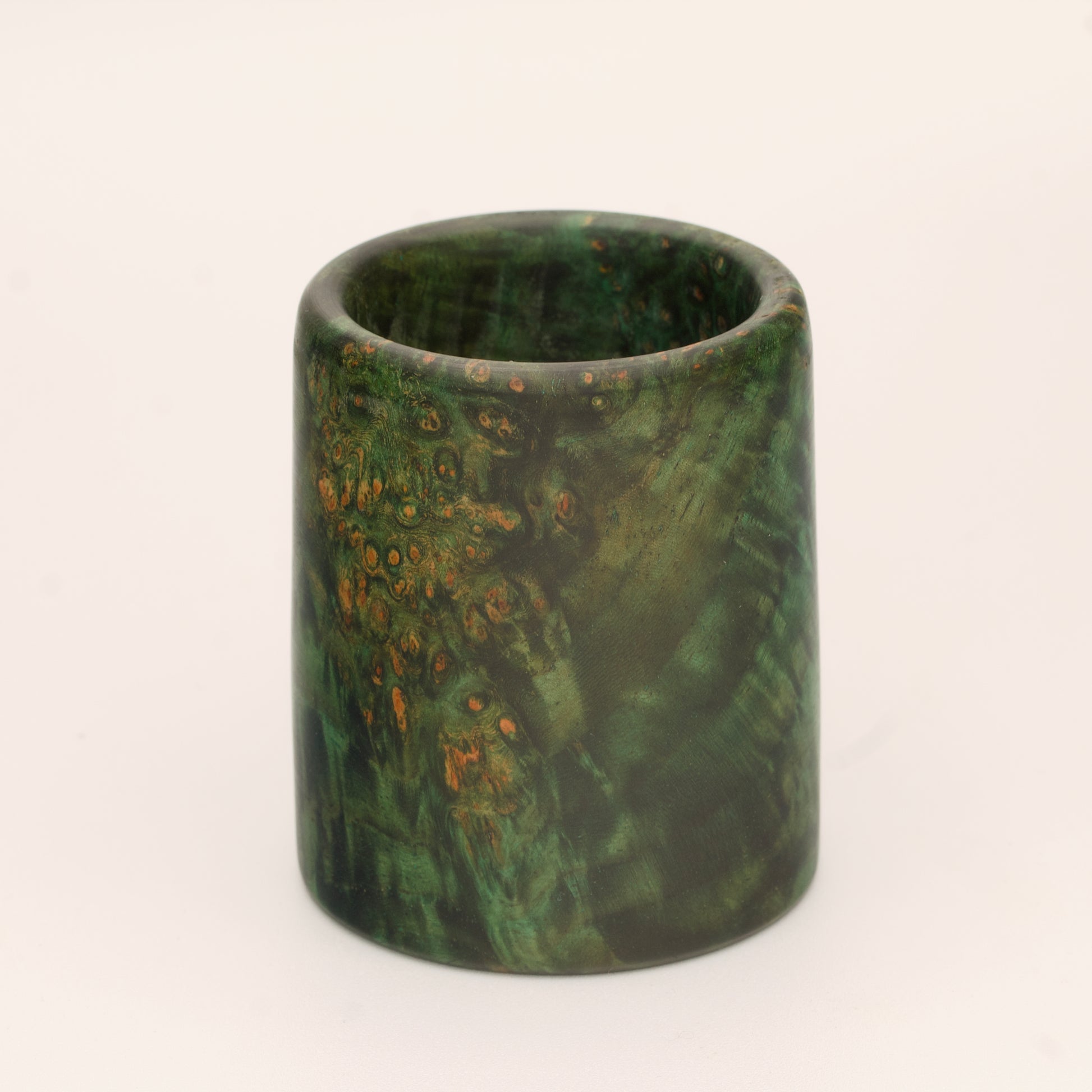 Green river tamarind burl wood shot glass against white background
