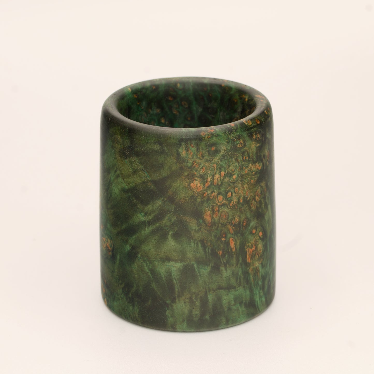 Green river tamarind burl wood shot glass against white background