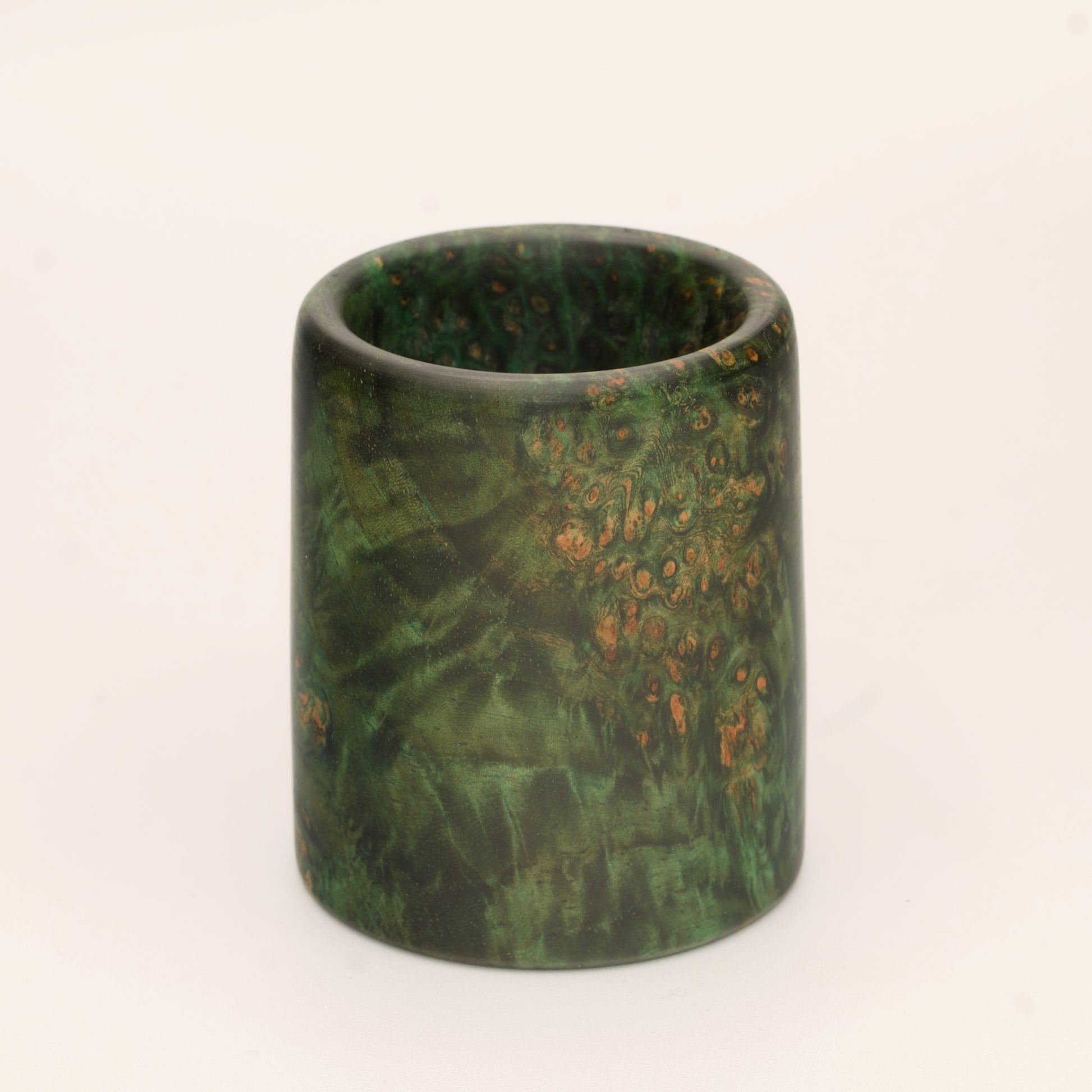 Green river tamarind burl wood shot glass against white background