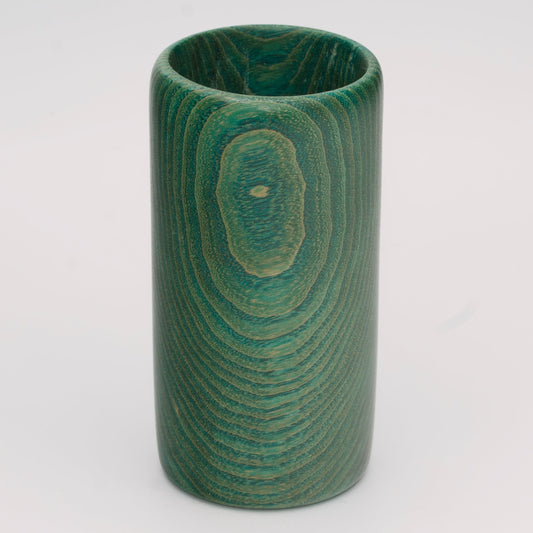 Green dyed oak wood shot glass against white background