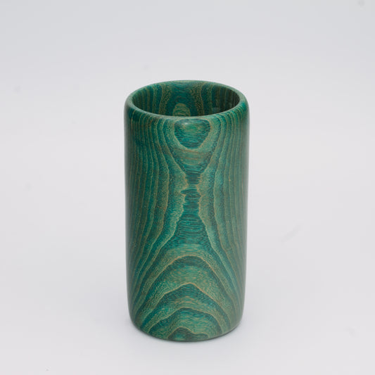 Green dyed oak wood shot glass against white background