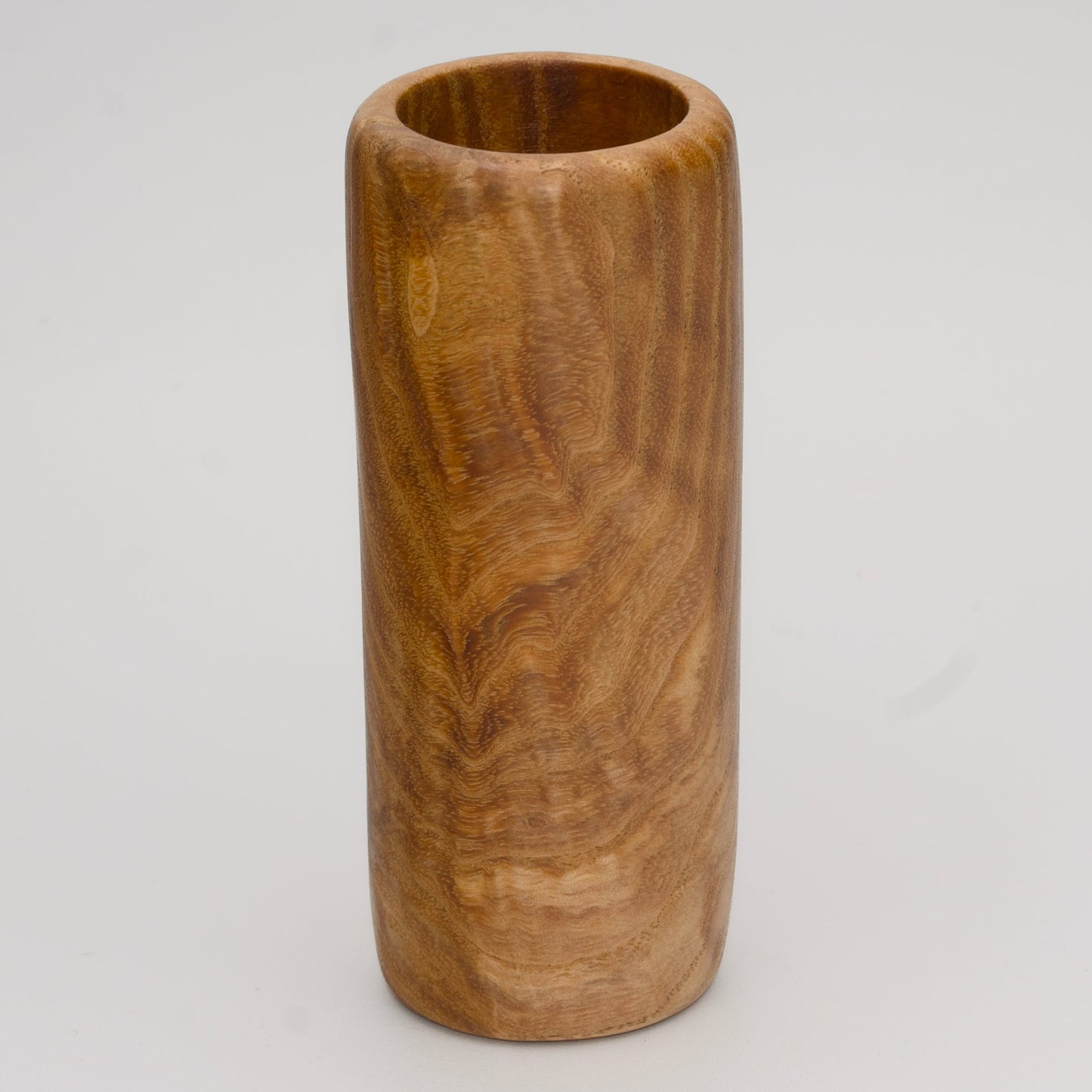 Figured Ash wood shot glass against white background
