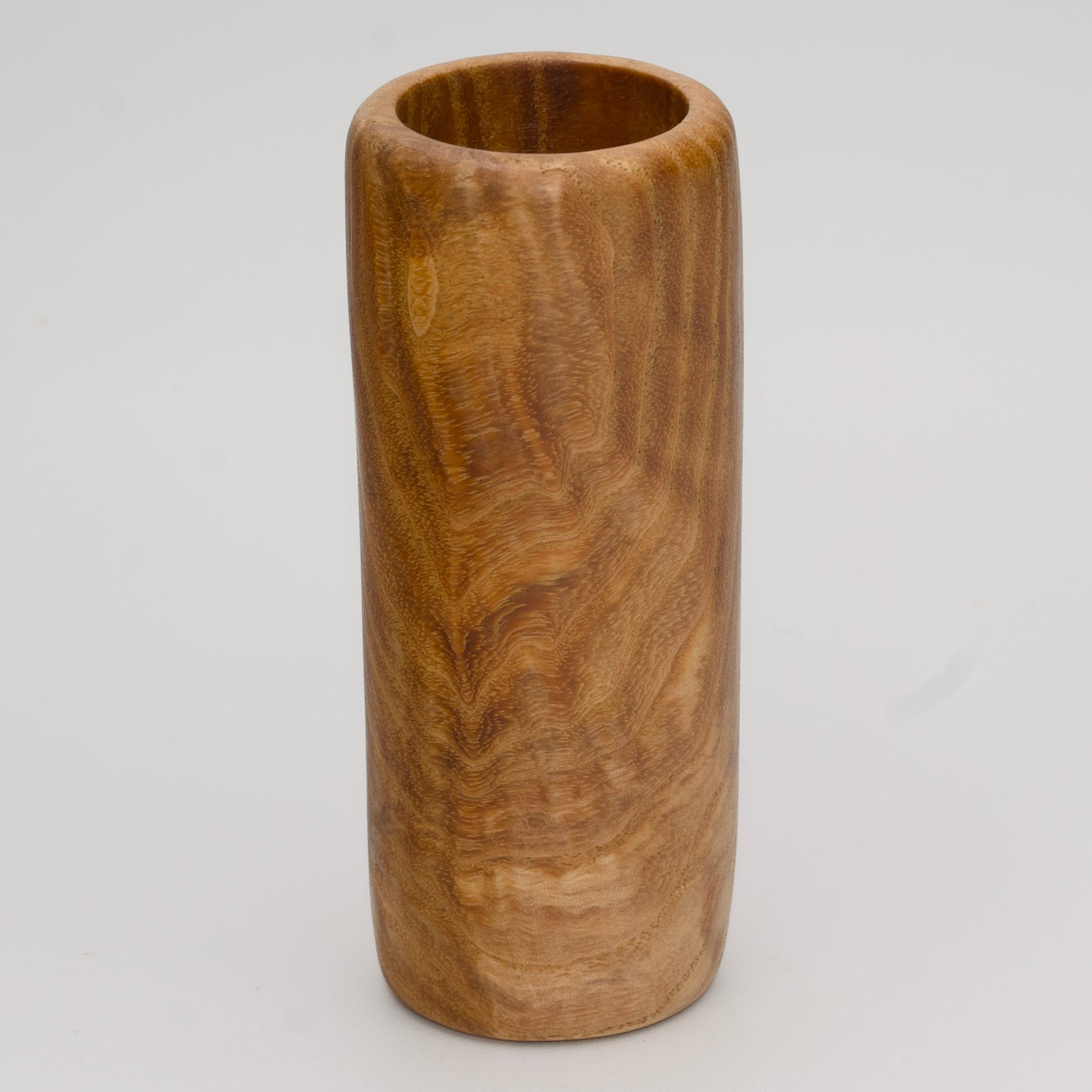 Figured Ash wood shot glass against white background