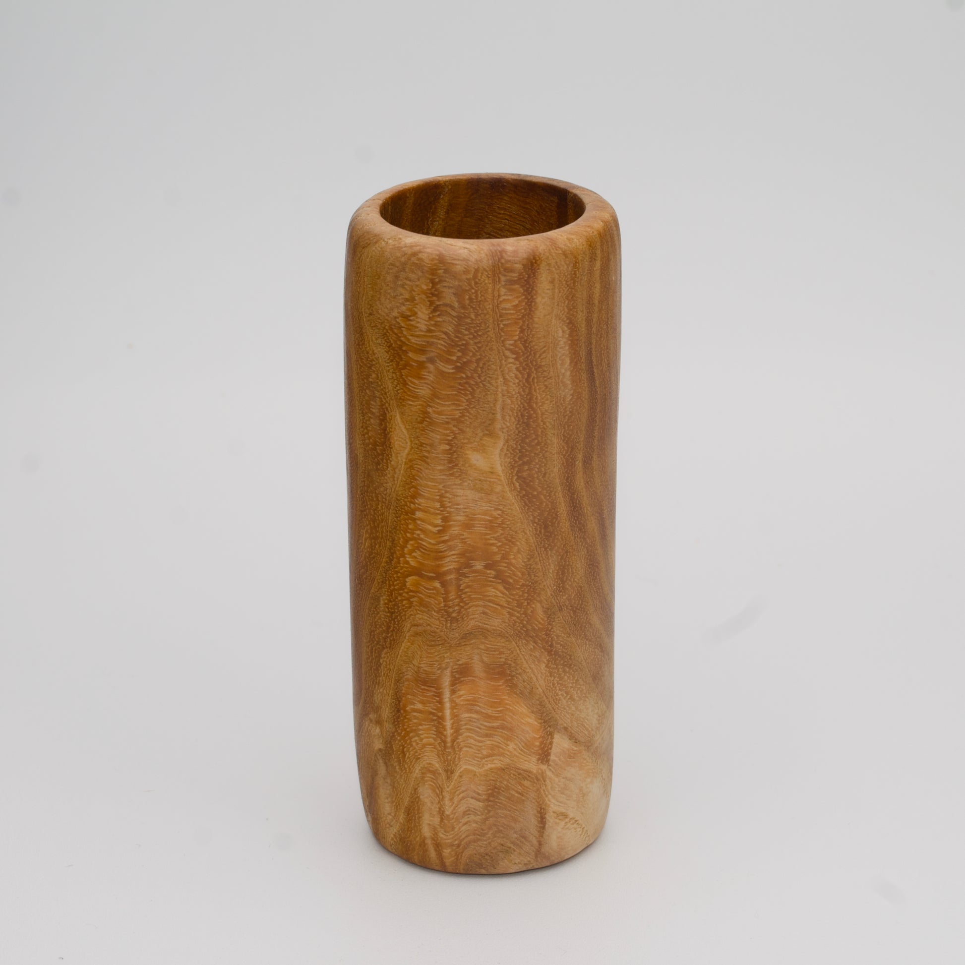 Figured Ash wood shot glass against white background