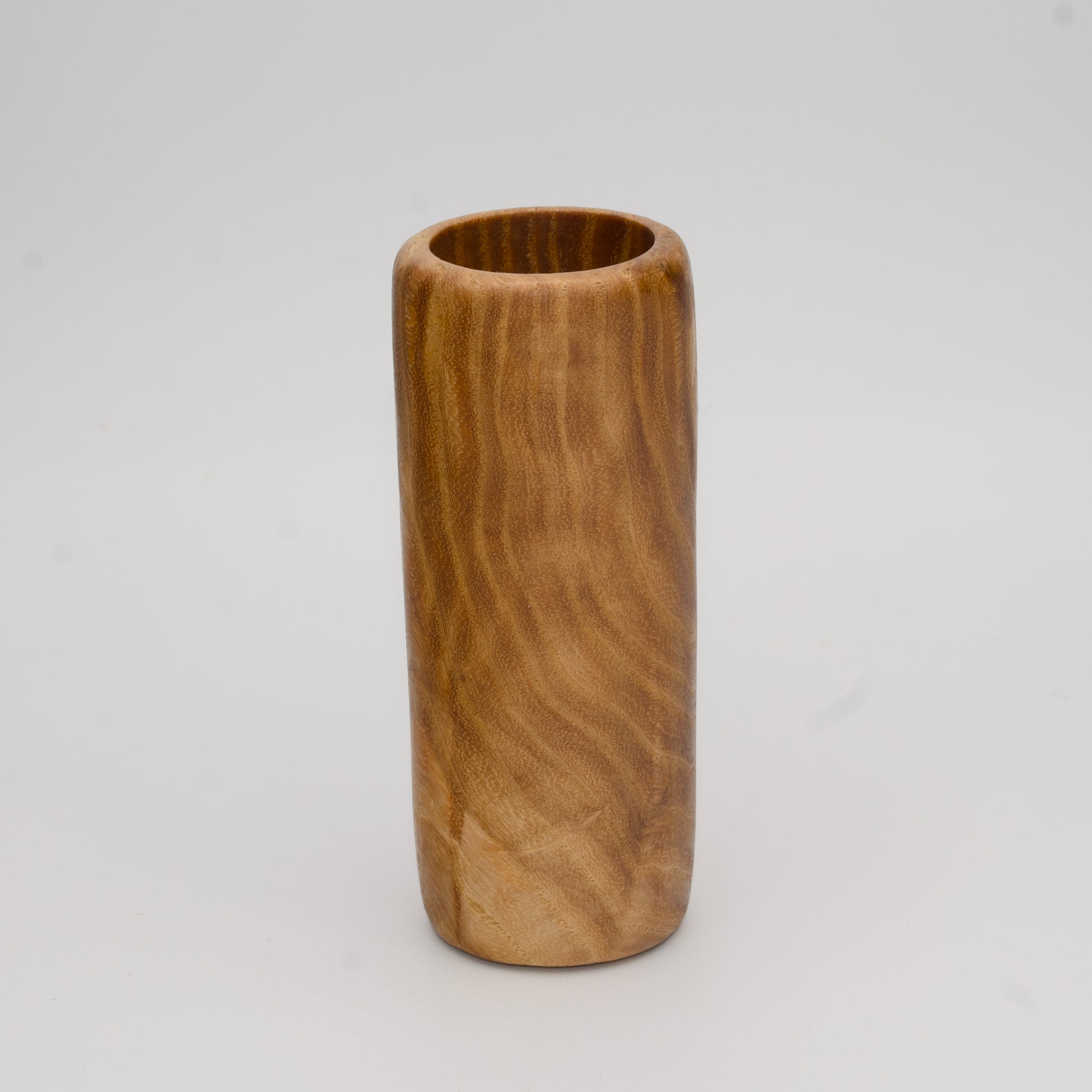 Figured Ash wood shot glass against white background