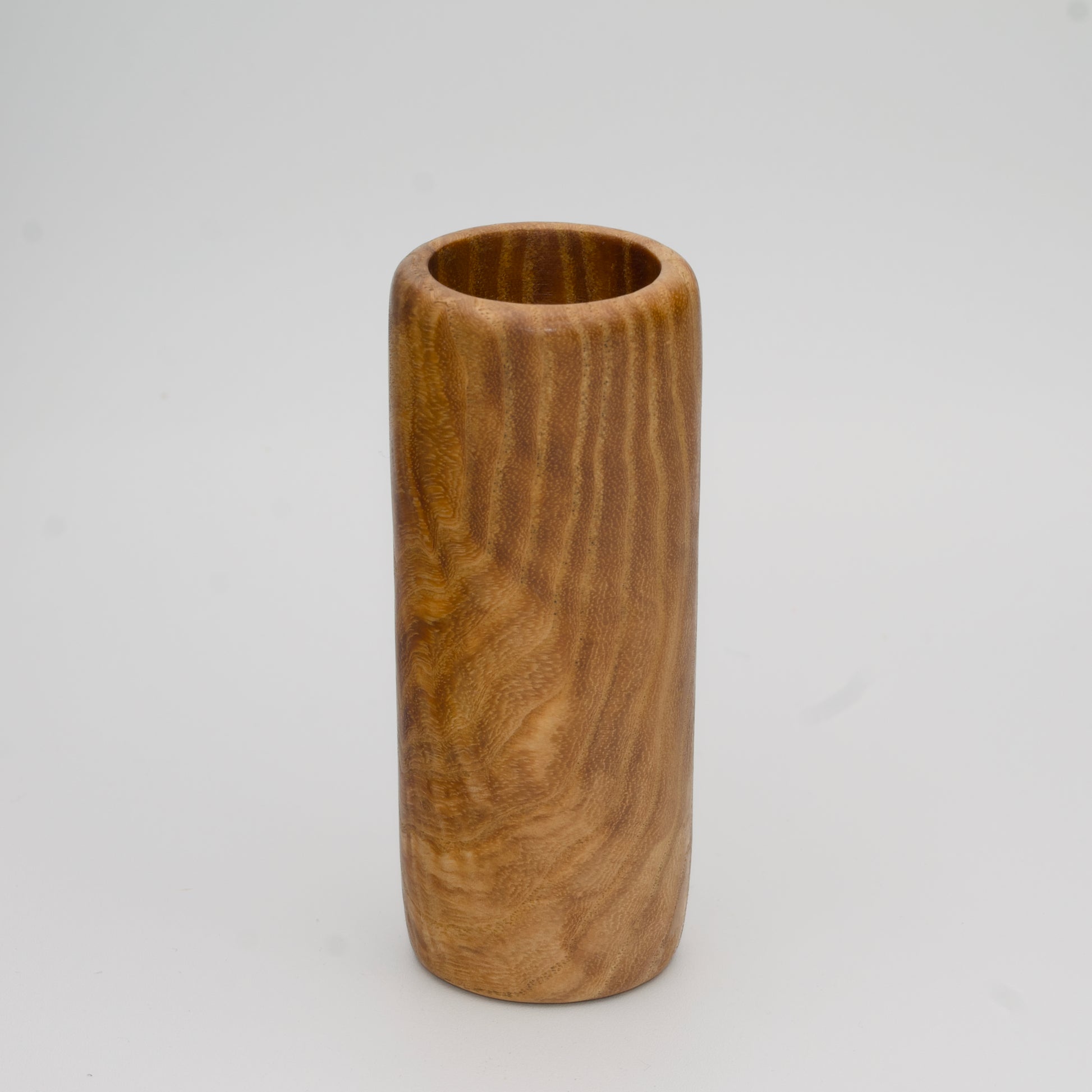 Figured Ash wood shot glass against white background
