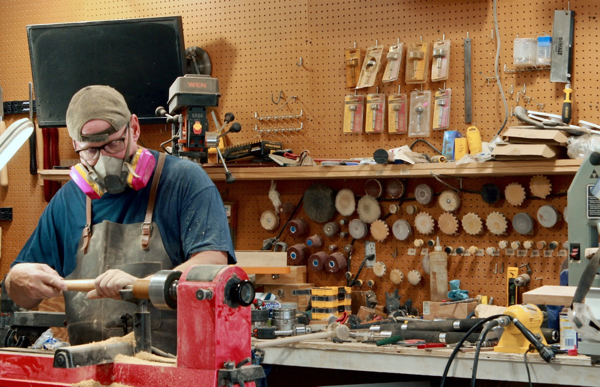 gentry crafted owner and craftsman working on a mango shot glass in his workshop