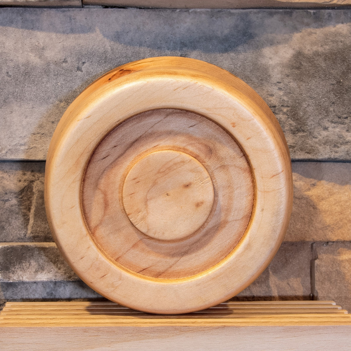 Underside of The Final Pass Maple bowl showing the recessed foot, circular grain, and small natural knot marks