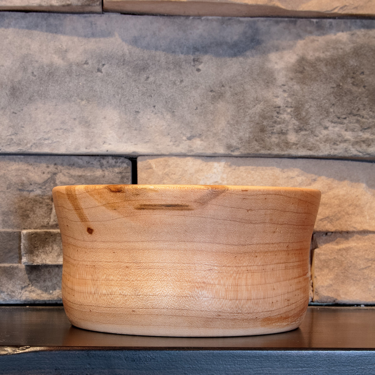 The Final Pass Maple bowl showing a paler exterior face with fine grain and darker figure near the rim