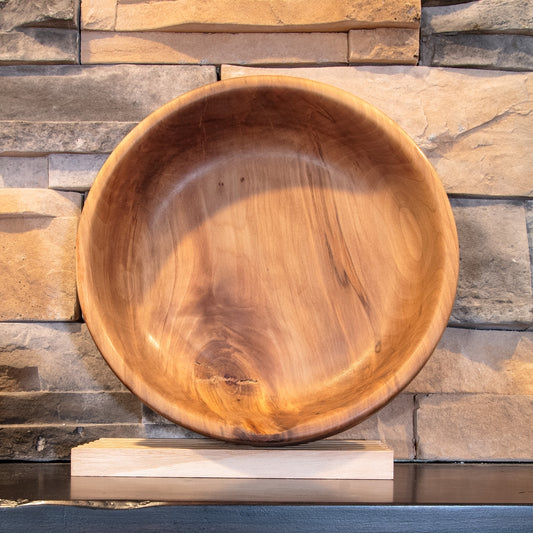 Interior of The Next Turn Sweetgum bowl showing sweeping warm grain, prominent natural knot, and rounded rim
